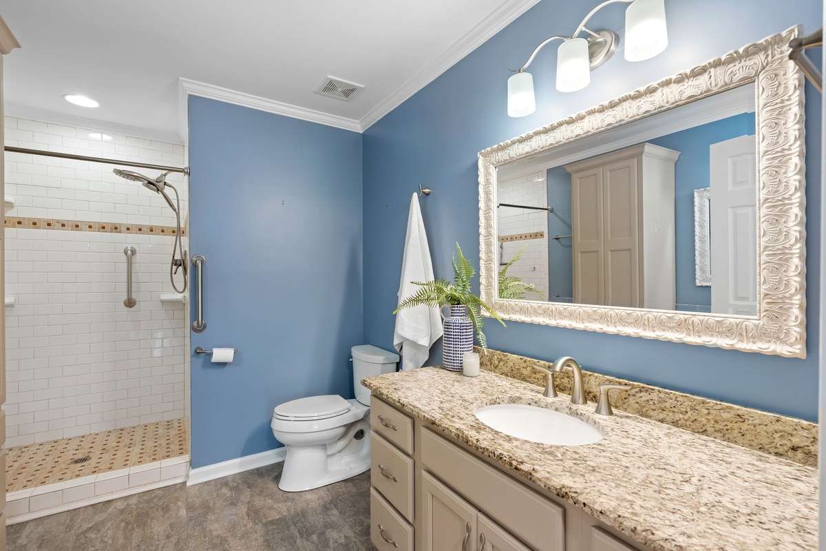 Updated vanity with stone-look countertops and a designer mirror!