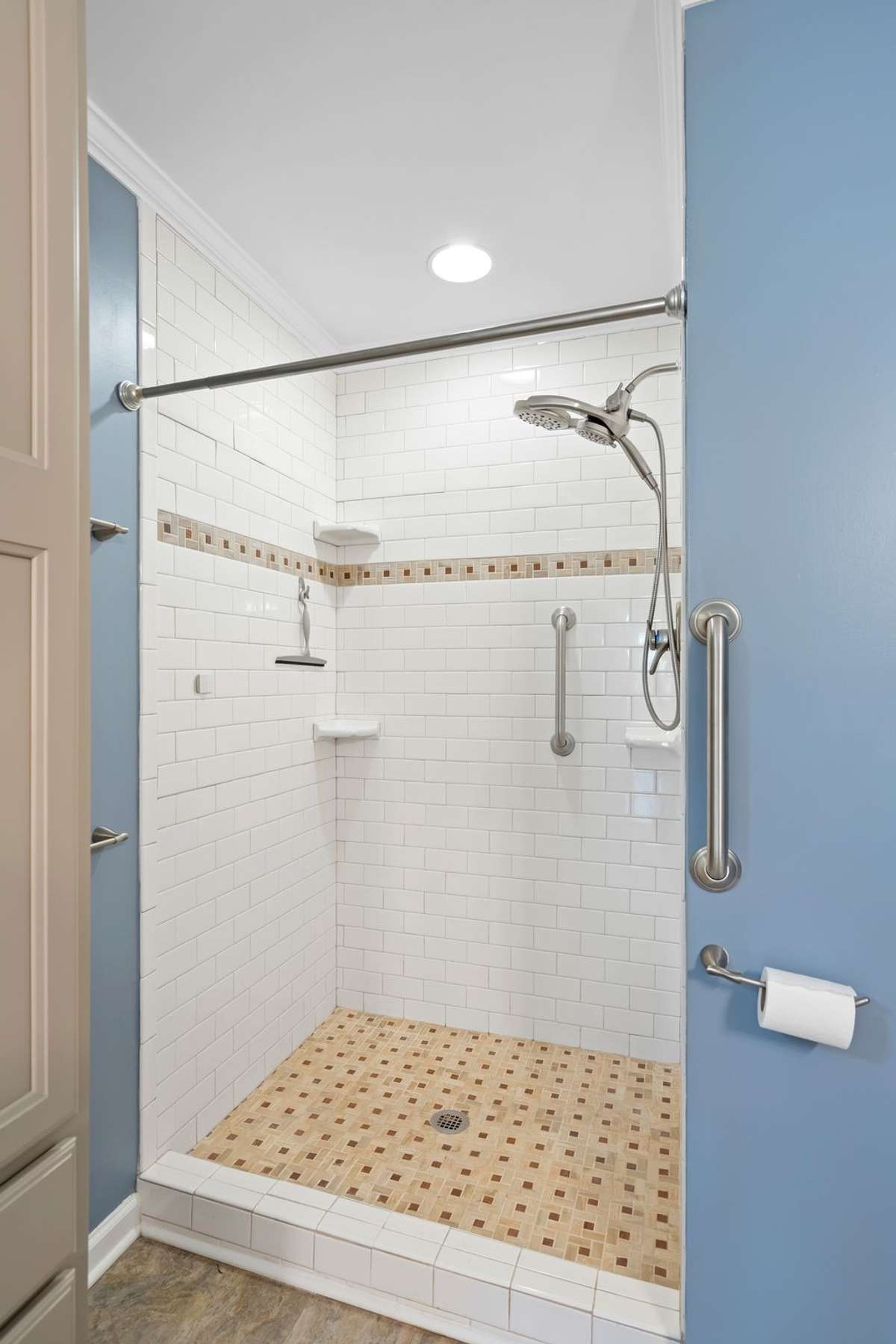 Stunning walk-in tile shower with stylish mosaic accents!