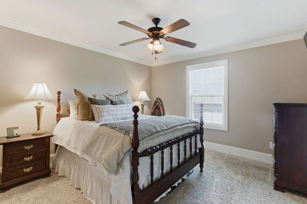 There is a large bedroom with a full bath upstairs.