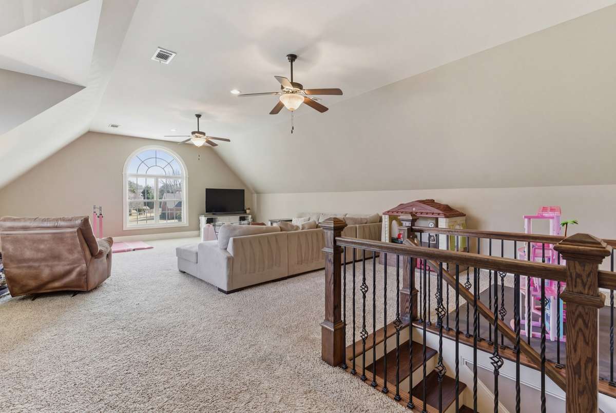 This large bonus room has tall ceilings & plenty of space for everyone to have dedicated areas of enjoyment.