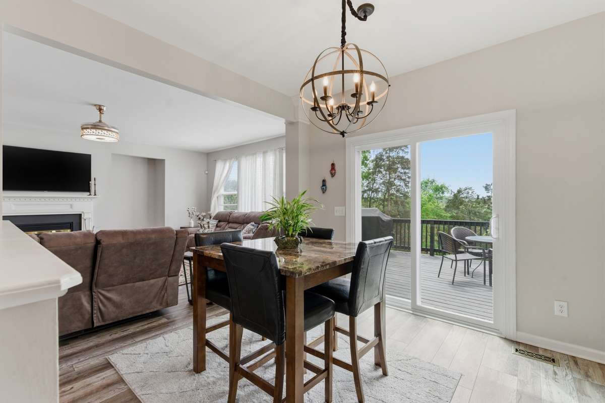 Newly installed sliding glass doors lead to the beautiful fenced backyard and deck.