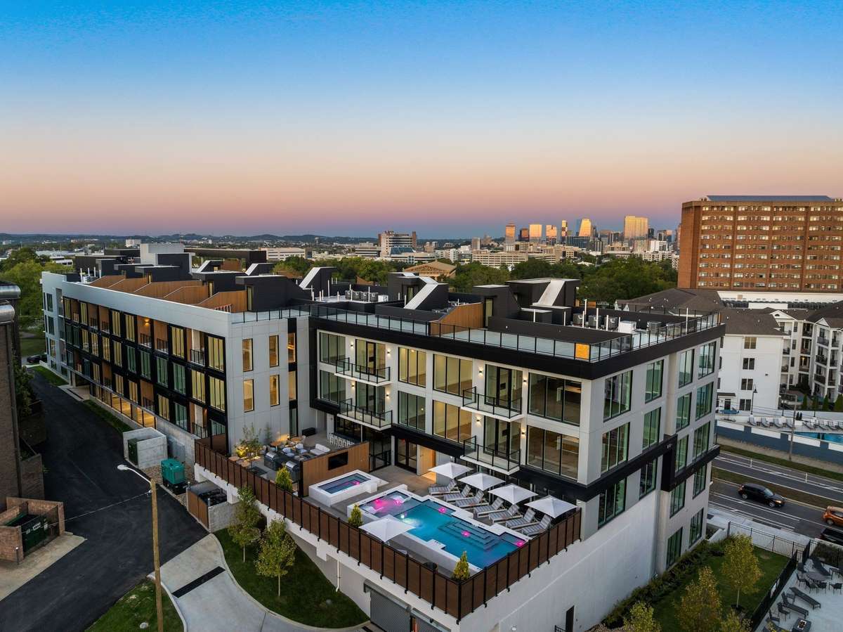 Premium amenities include a resort-style pool and hot tub, sauna, on-site concierge, a fully equipped gym, comfort stations offering snacks and coffee, firepit and outdoor dining spaces, and a rooftop with unbeatable views.