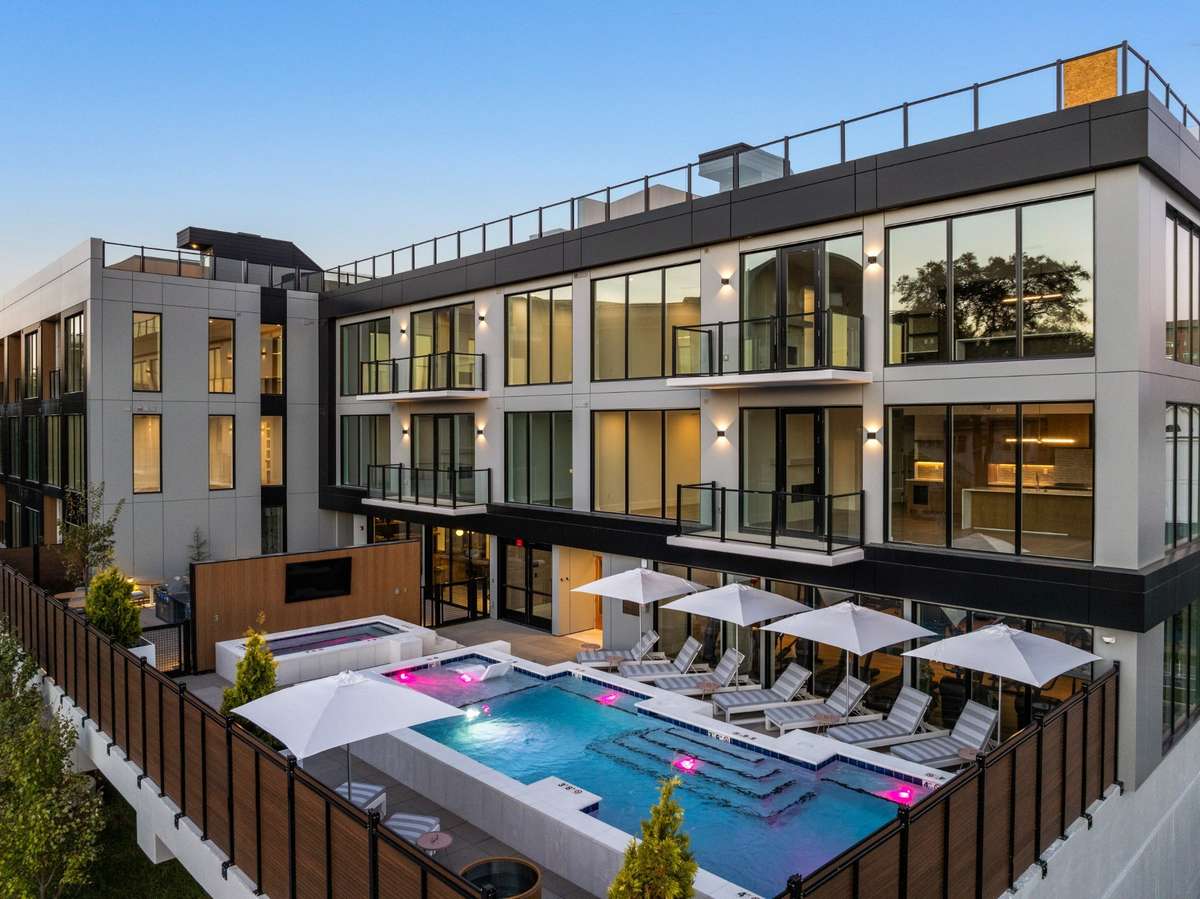 Premium amenities include a resort-style pool and hot tub, sauna, on-site concierge, a fully equipped gym, comfort stations offering snacks and coffee, firepit and outdoor dining spaces, and a rooftop with unbeatable views.