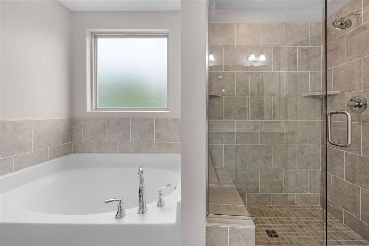 This is a nicely upgraded fully tiled shower with frameless glass.