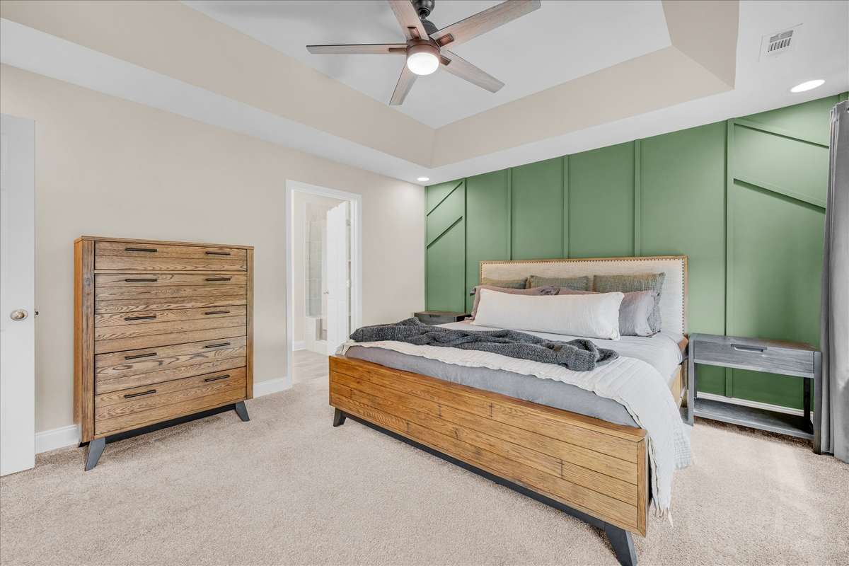Primary bedroom with custom accent wall. This room is the perfect size.