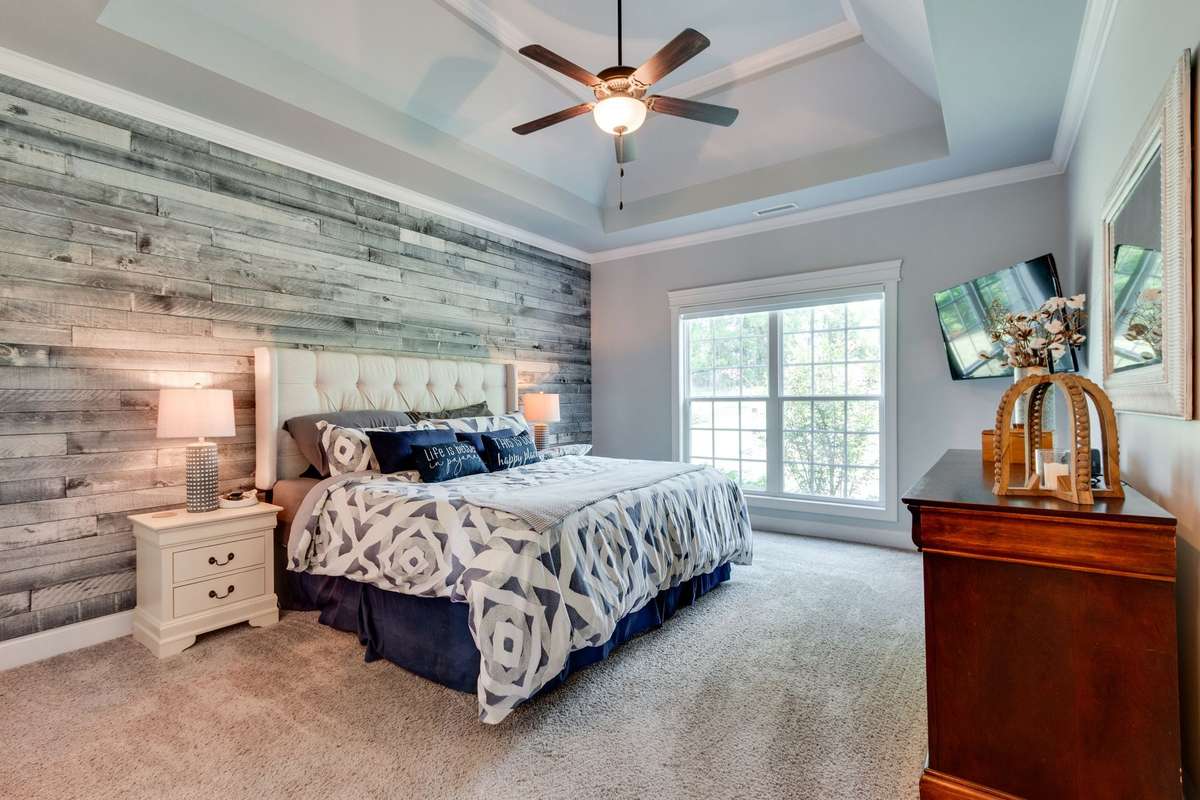 primary bedroom with a double trey ceiling