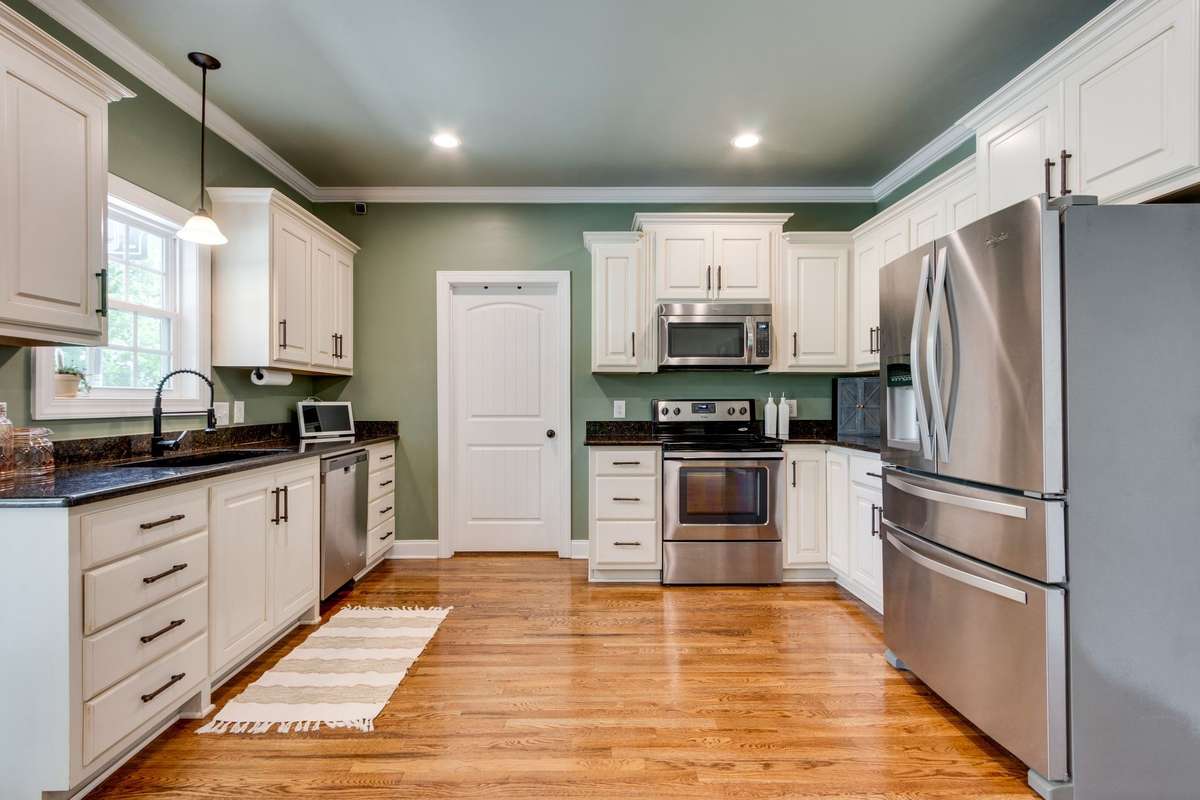 Chef's kitchen with an abundance of cabinet space and a pantry