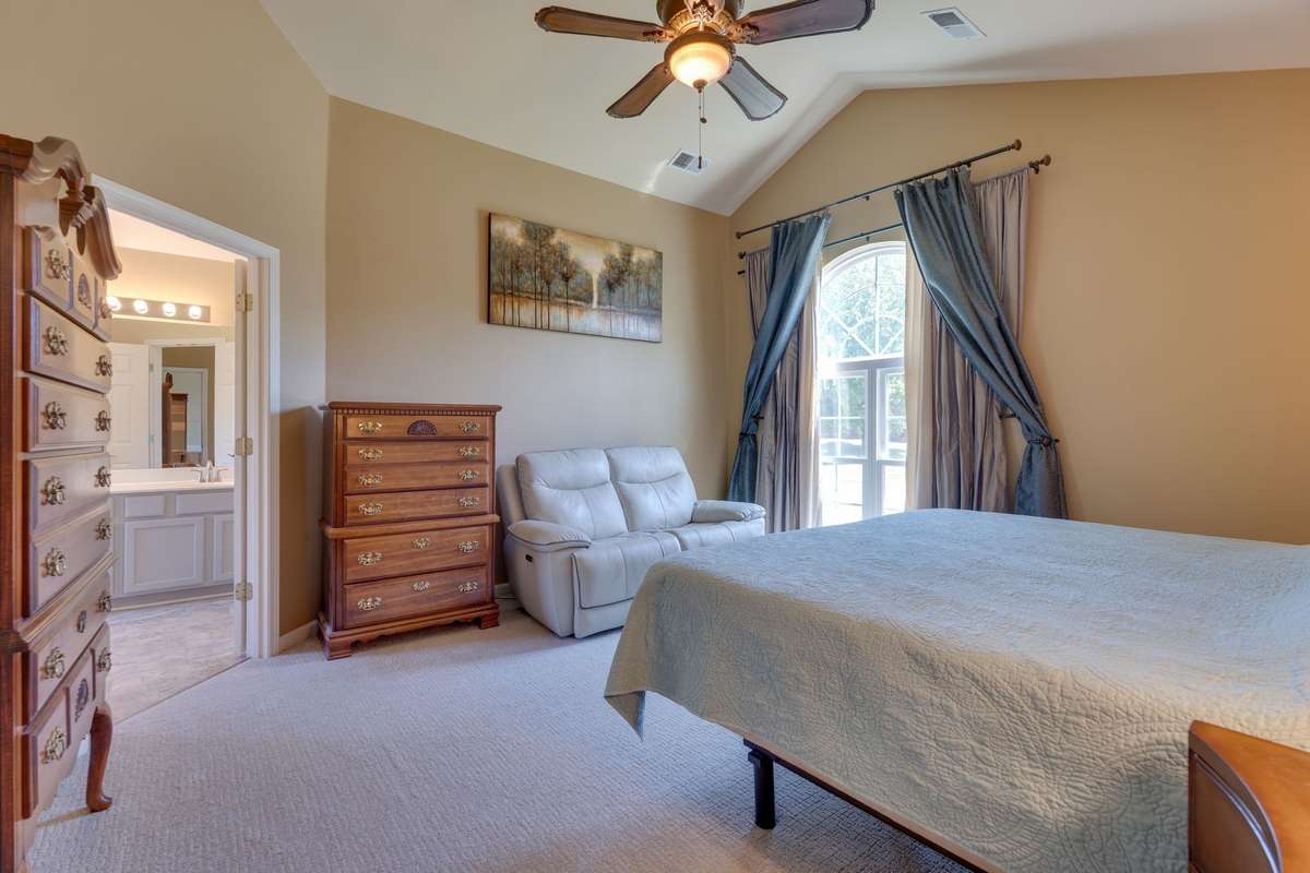 Mid-Level Primary Suite with vaulted ceiling and new lighting