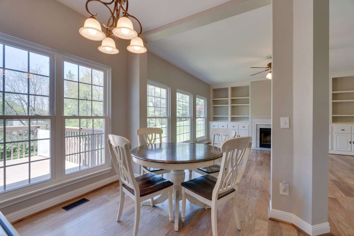 The inviting eat-in nook creates a natural transition between the kitchen and den