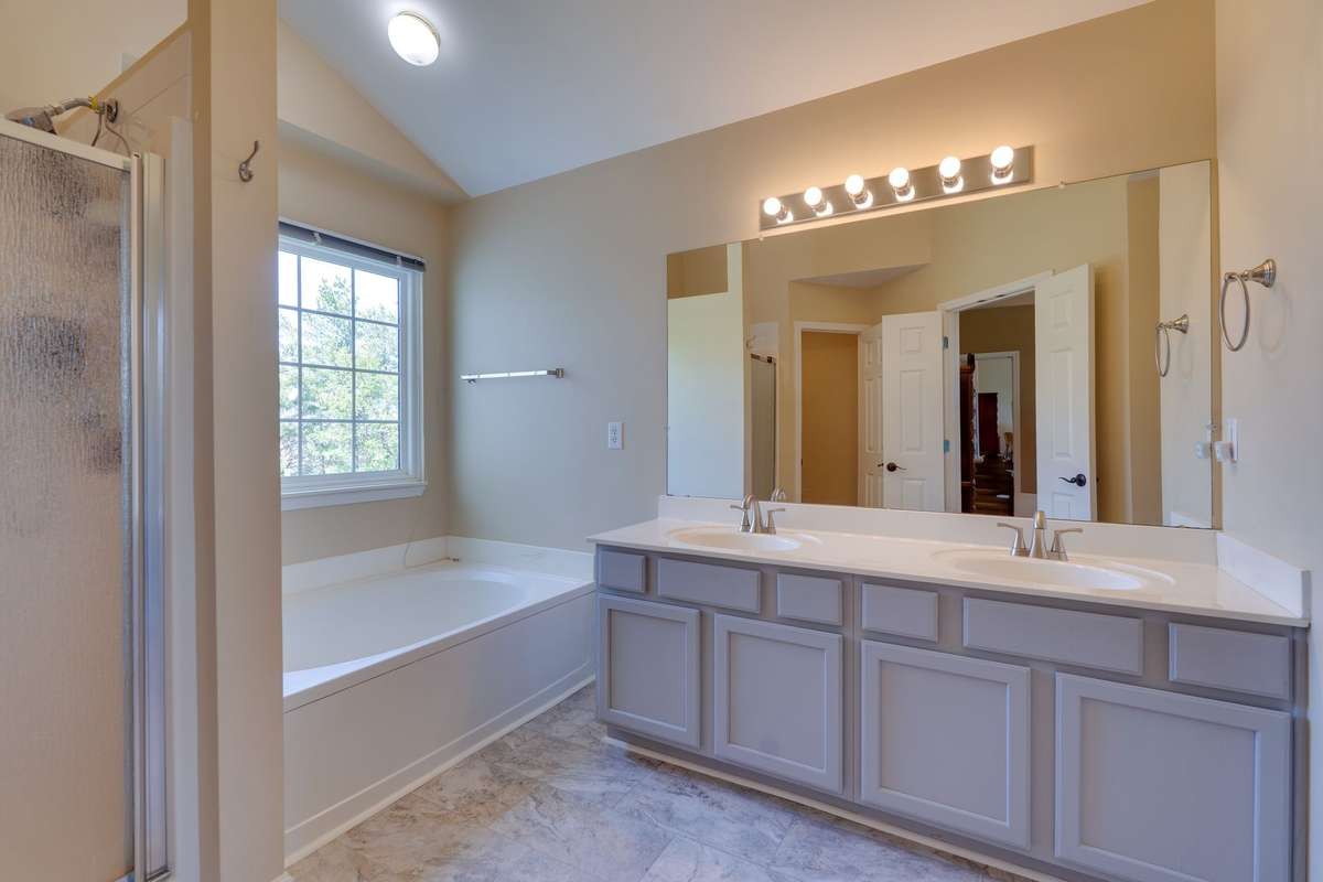 Primary bath has separate shower & tub with canned lighting