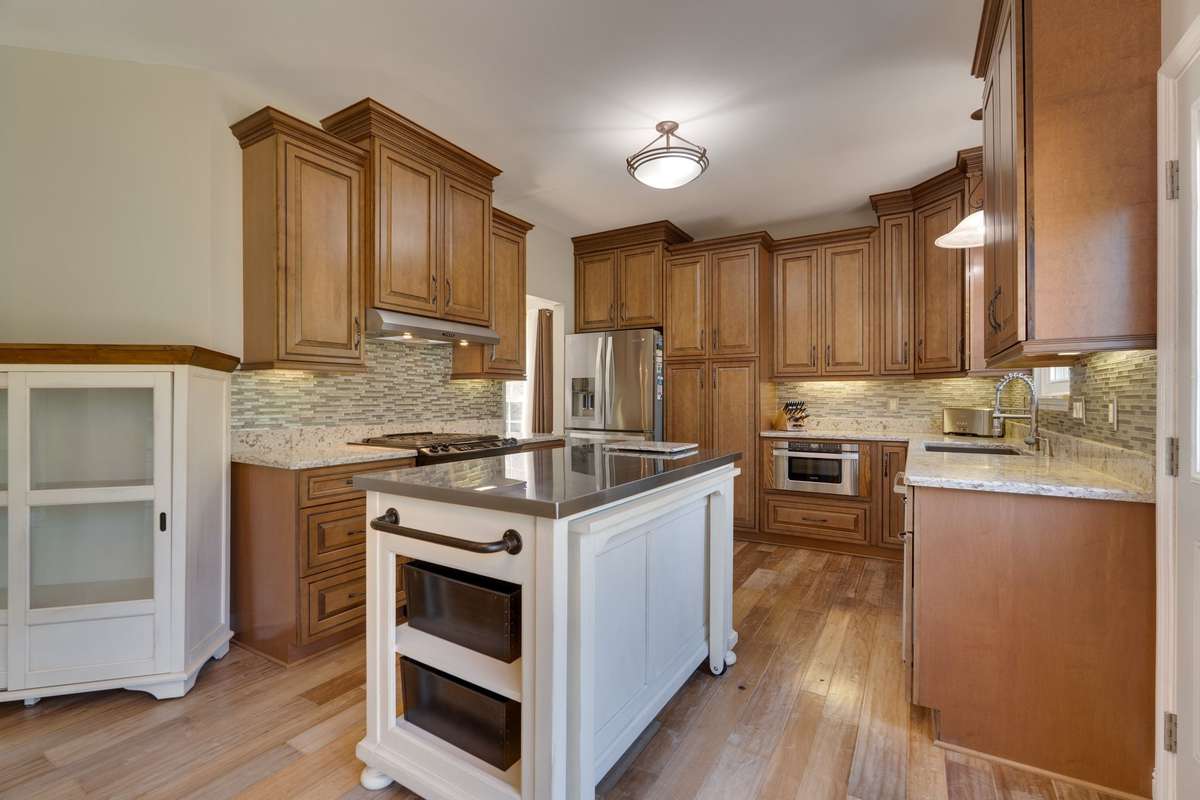 Remodeled kitchen features Cambria quartz countertops, stainless steel appliances & Insinkerator disposal