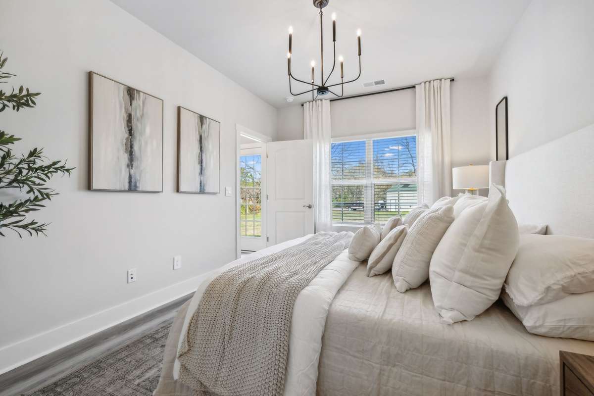 Photo of similar home in the same community - primary on the main level with one car garage. Upgrades available. Closing cost assistance available. Contact the onsite agent - model home open Wednesday-Saturday 10-5 and Sunday 1-5.