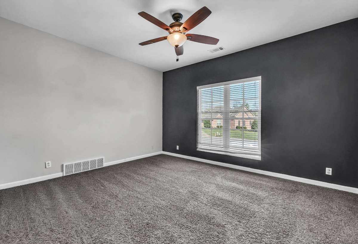 Bedroom 3 is located upstairs & features a fun accent wall.