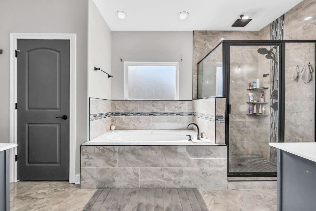 The en suite includes a large soaking tub + walk in tiled shower + separate water closet.