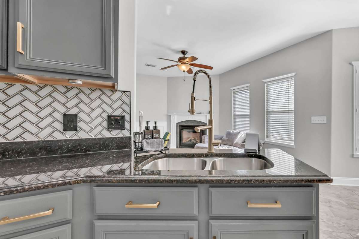 The kitchen flows seamlessly to the den area.