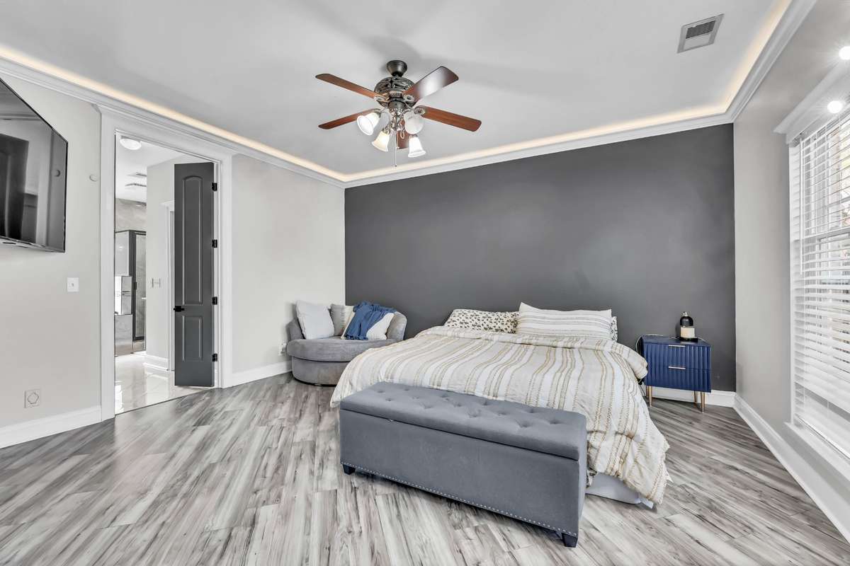 The primary bedroom is located on the main level & includes two walk in closets + en suite.