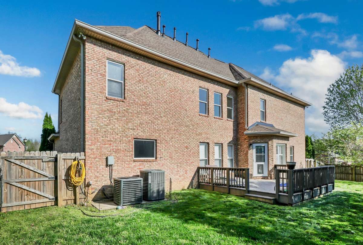 Step outback to a nice level backyard with privacy fence + deck.