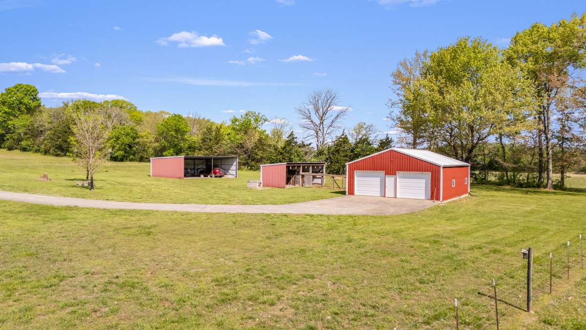 Fully powered 30x40 shop with two garage doors and a concrete floor—great for projects, storage, or equipment. There’s also a barn and equipment shed for extra space.