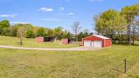 Fully powered 30x40 shop with two garage doors and a concrete floor—great for projects, storage, or equipment. There’s also a barn and equipment shed for extra space.
