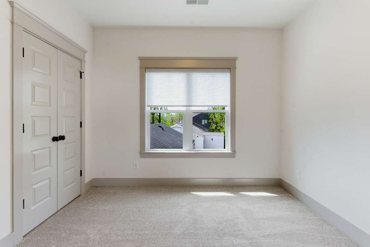 Upstairs second bedroom with new carpet and connecting full bath
