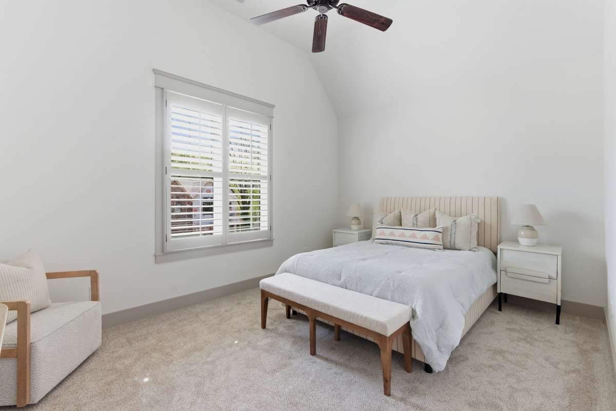Upstairs primary suite with new carpet and vaulted ceiling