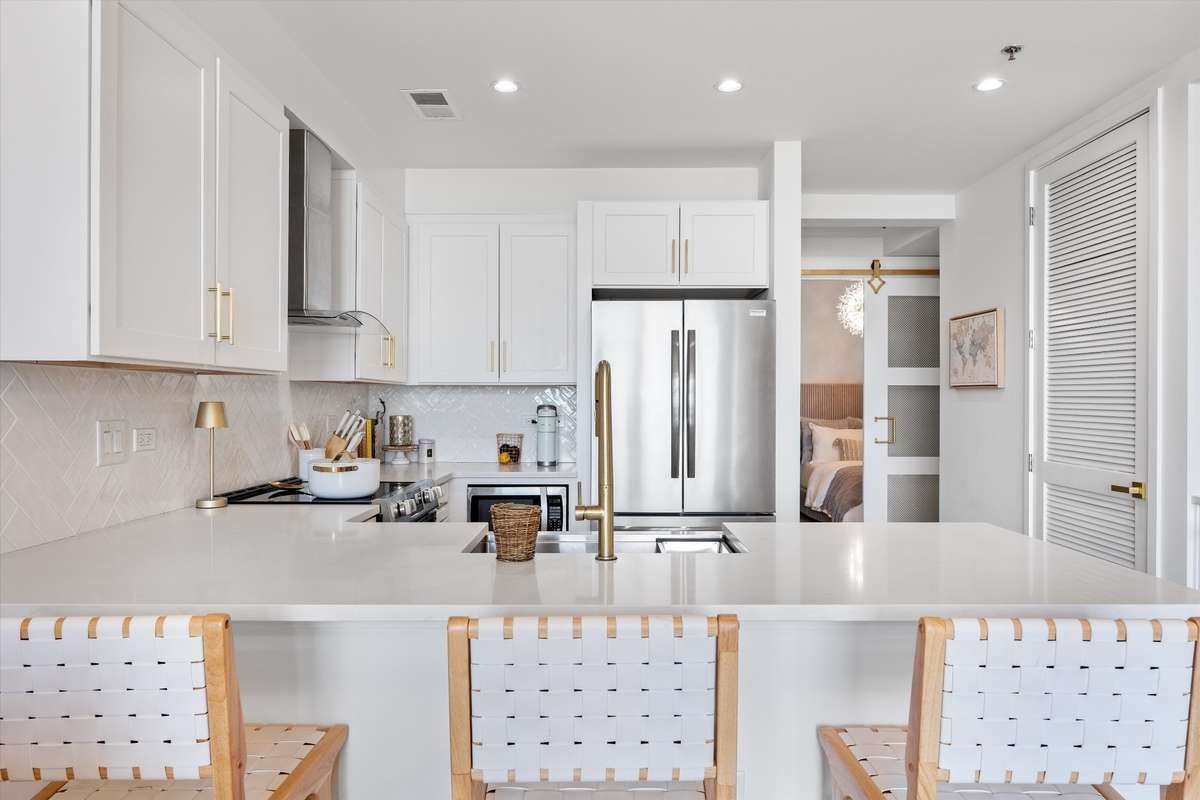 Another view of the kitchen with beautiful and durable quartz counter tops! You can also see the custom sliding bedroom door!!