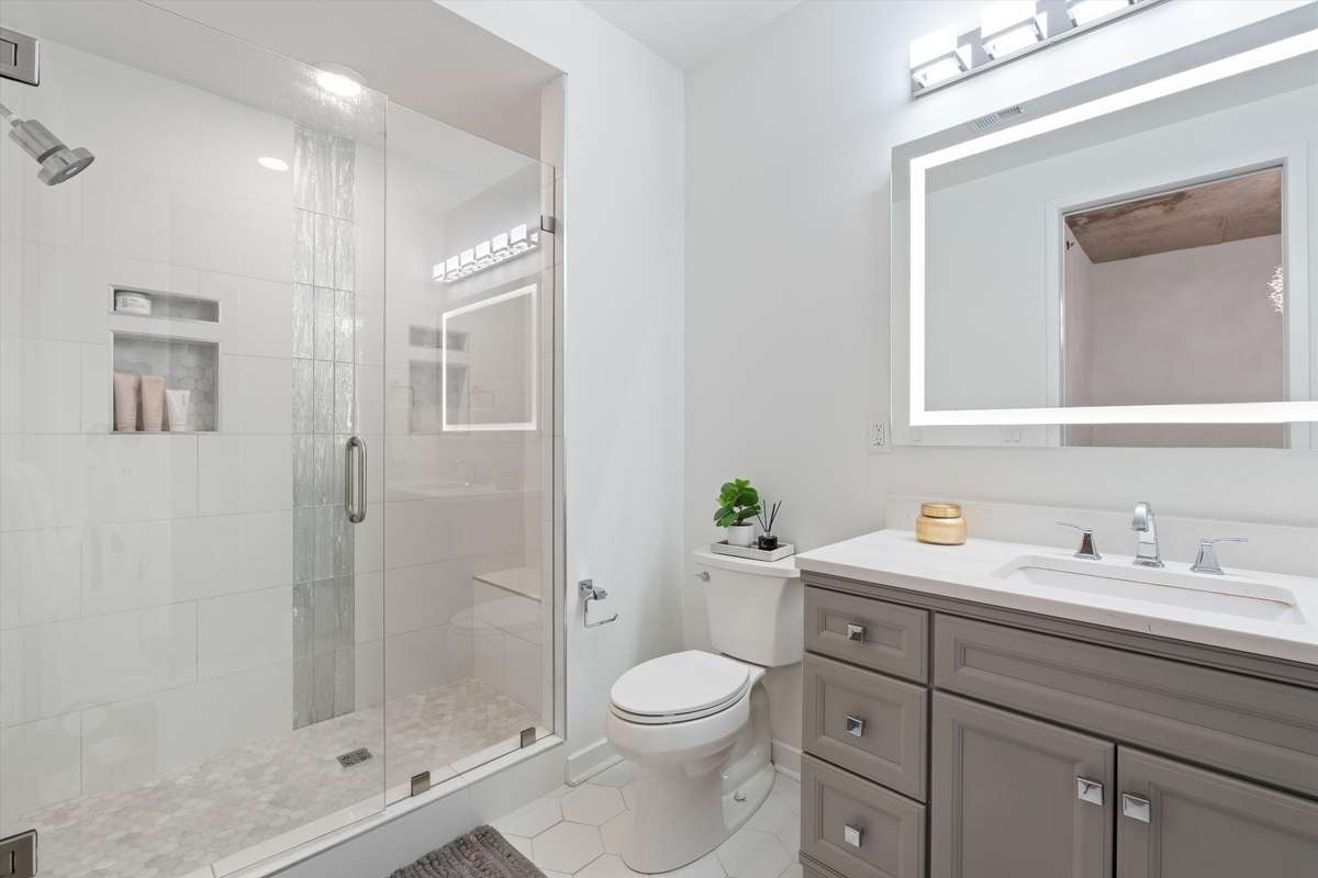 New custom tiled shower with frameless glass enclosure