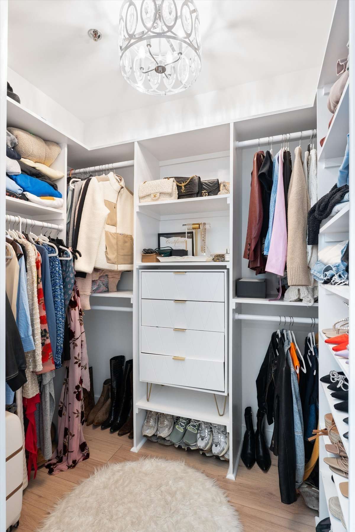 Custom closet with chandelier lighting. So much storage!!