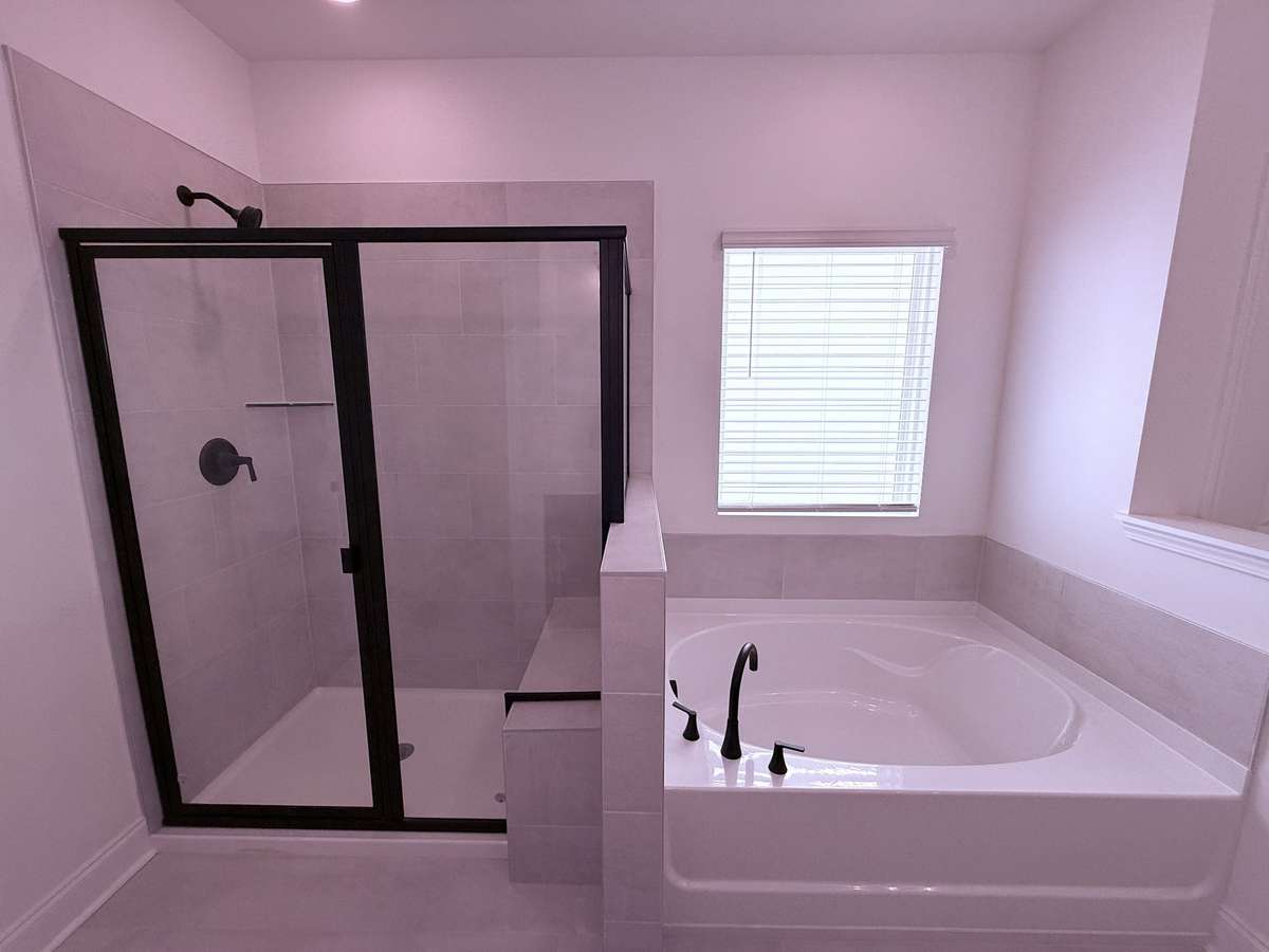 ***Picture taken on 4/1/26 to show the current status of construction***

Unwind in the tiled shower with its built-in bench, or enjoy a quiet, soothing soak in the garden tub.