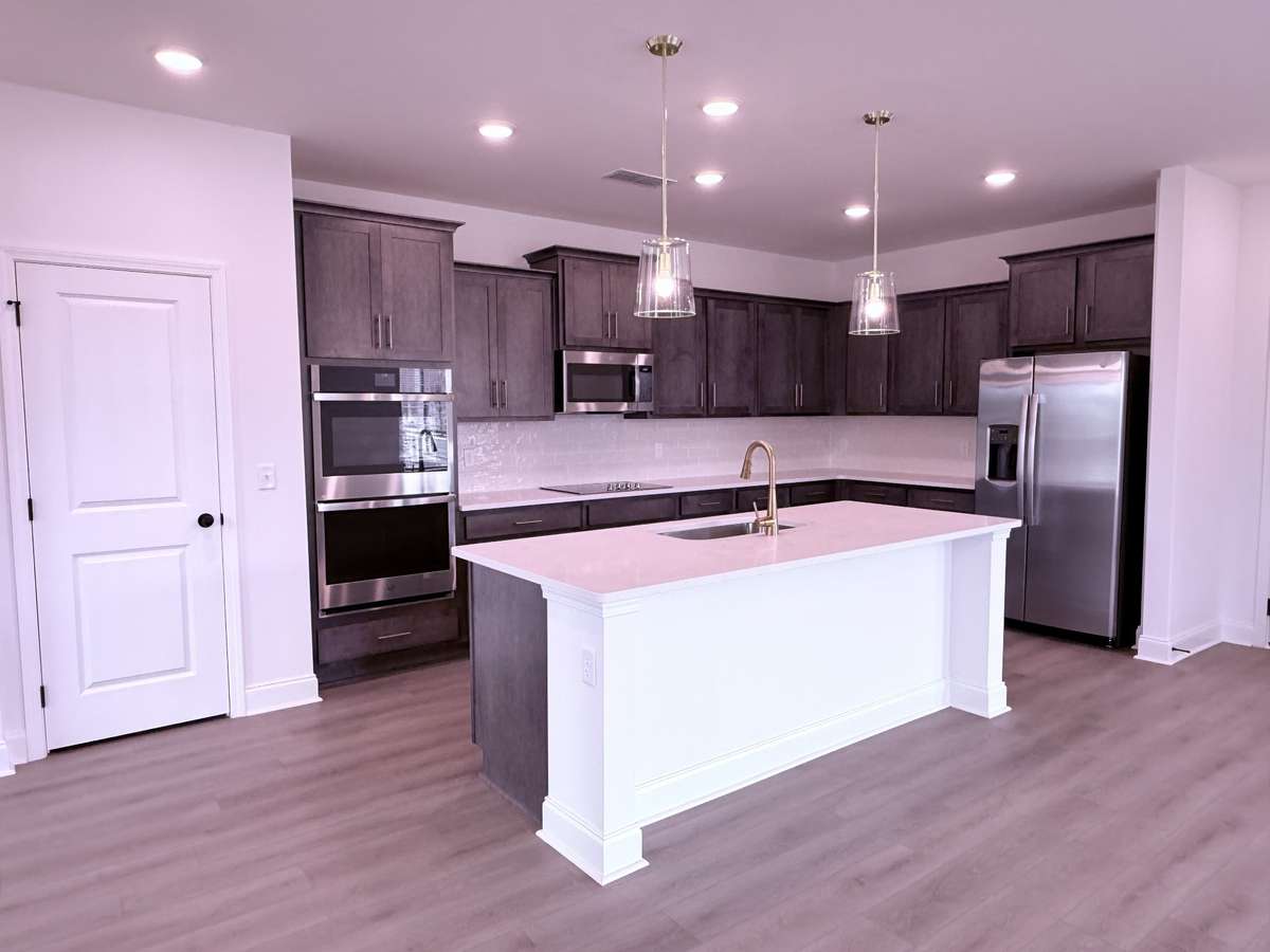 ***Picture taken on 4/1/26 to show the current status of construction***

The gourmet kitchen features beautiful wood-stained cabinetry with soft-close doors, combining timeless style with everyday functionality.