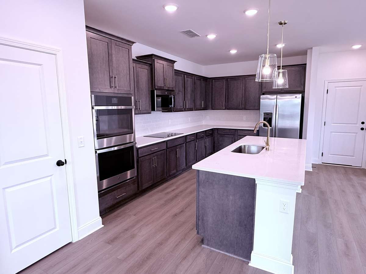 ***Picture taken on 4/1/26 to show the current status of construction***

Enjoy a gourmet kitchen with stainless steel appliances, highlighted by a double oven and electric cooktop, perfect for entertaining and everyday cooking.