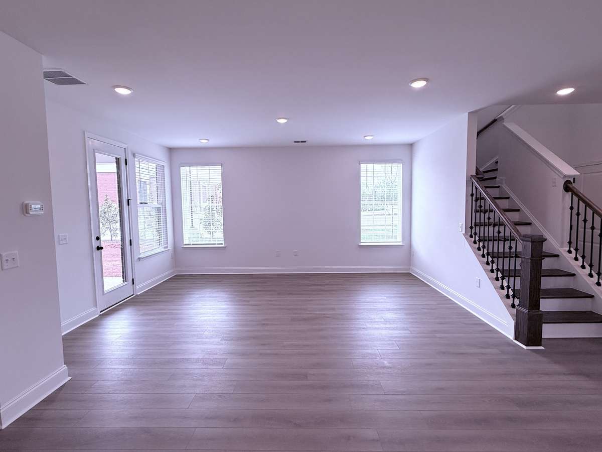 ***Picture taken on 4/1/26 to show the current status of construction***

The first floor features stylish LVP flooring, and the great room is enhanced by large windows that flood the space with natural light, perfect for entertaining or relaxing.