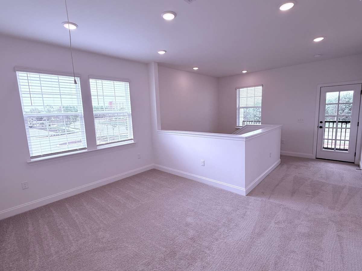 ***Picture taken on 4/1/26 to show the current status of construction***

The second-floor loft features direct access to a covered balcony and serves as a flexible space for a home office, study, play area, or quiet retreat.