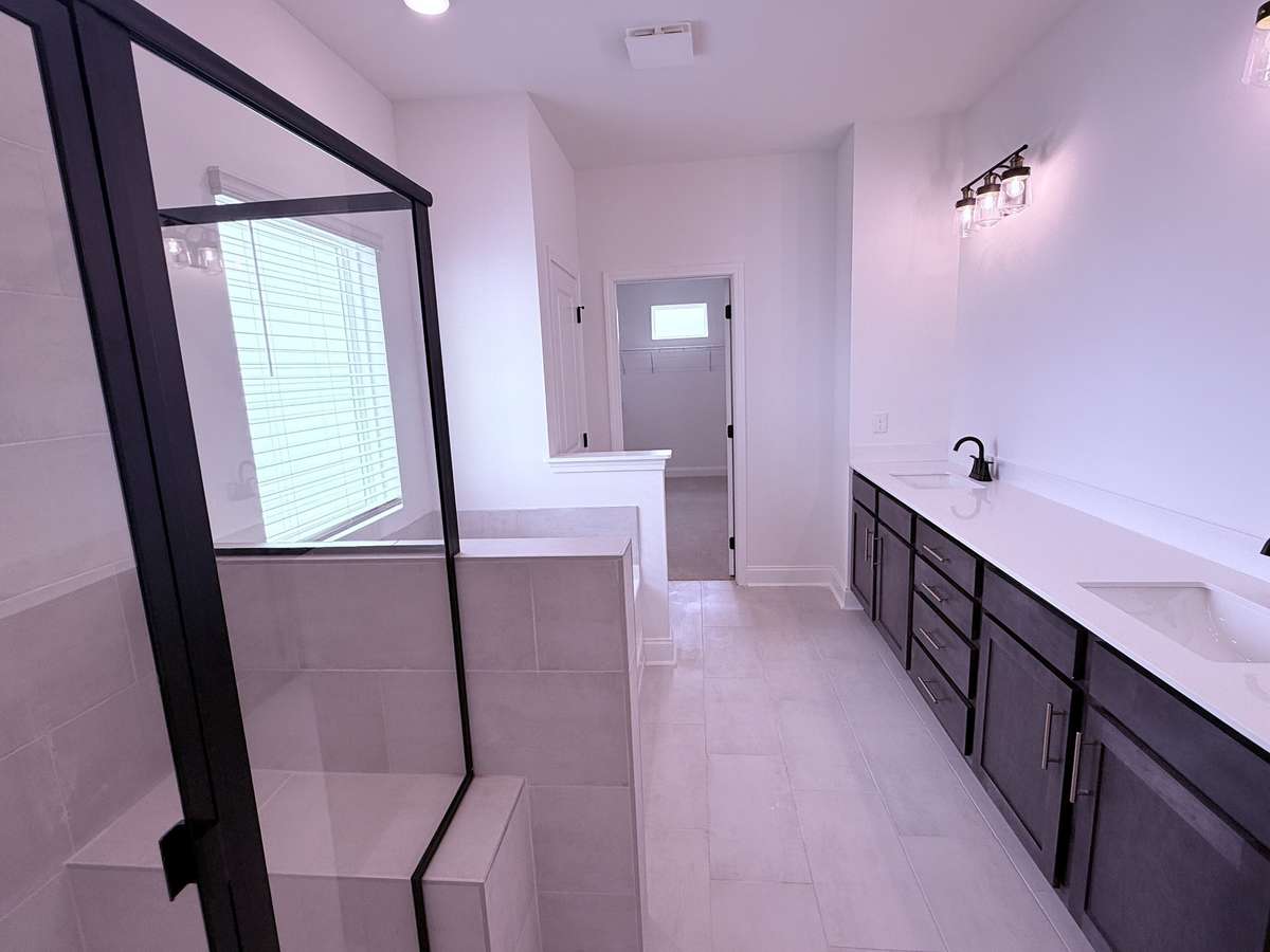 ***Picture taken on 4/1/26 to show the current status of construction***

Enjoy a spa-like primary bathroom with tile flooring, dual sinks with quartz countertops, a tiled shower with bench, garden tub, and an expansive walk-in closet.