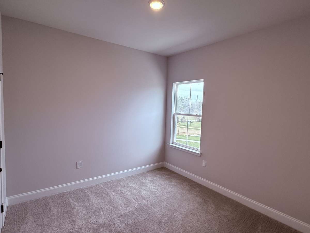 Bedroom 2 is located upstairs and features a generous walk-in closet, providing ample storage space and keeping the room organized and clutter-free.