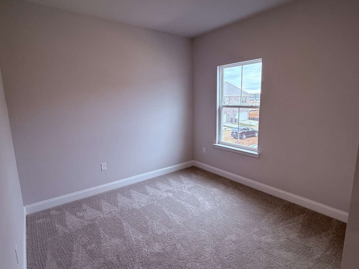 Bedroom 3, located on the second floor, offers a bright and comfortable space ideal for family, guests, or a flexible home office. Its convenient location near the loft and bathrooms makes it functional and accessible.
