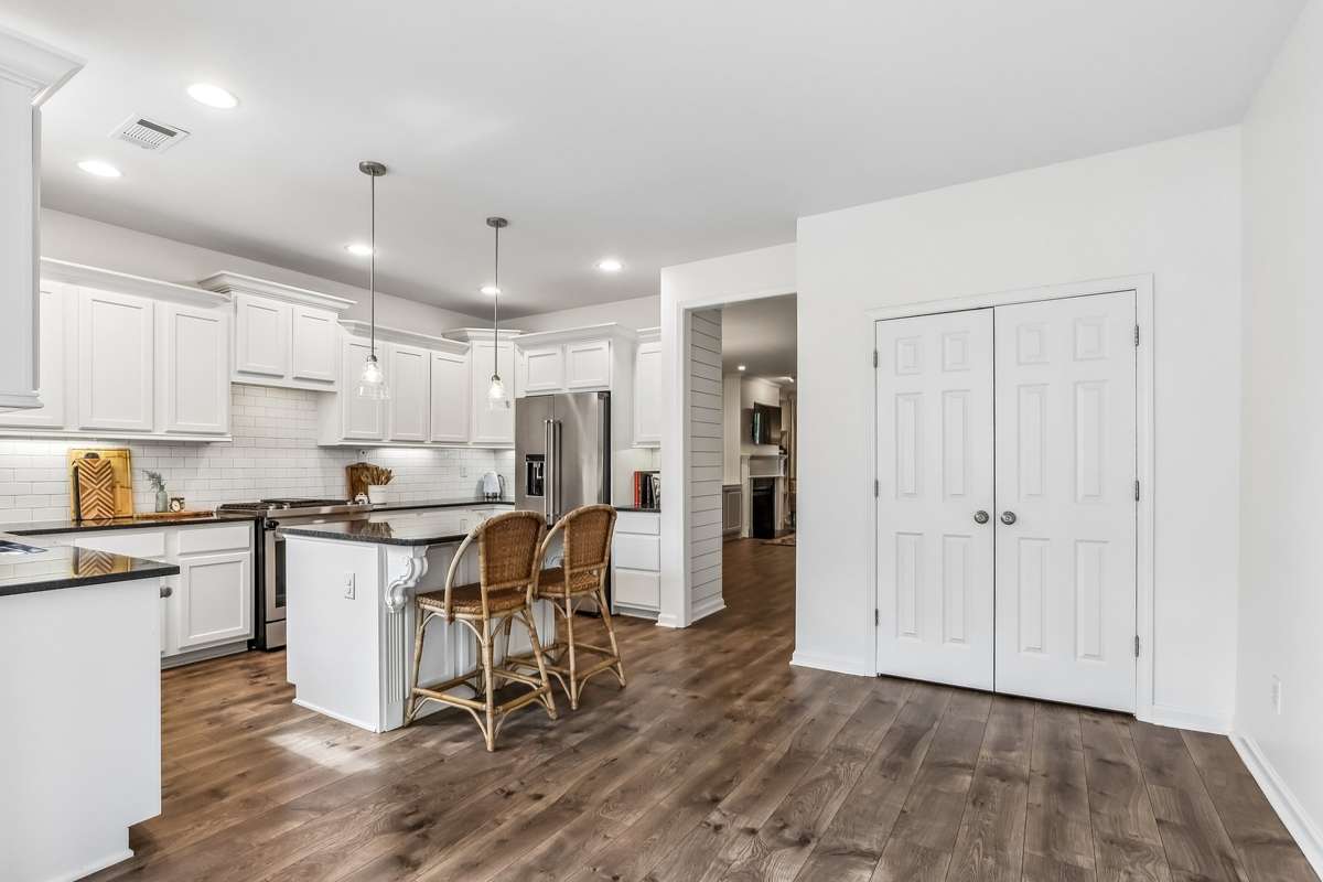 Custom pantry and room for another dining table, desk, or even additional cabinets.
