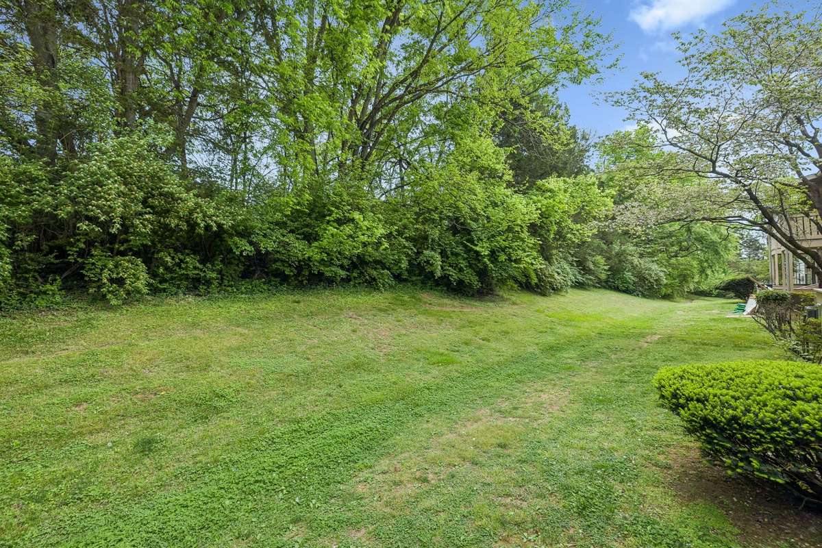This large open area is available for residents to enjoy.  This one is located behind the condo.and backs to trees.  Perfect for walking pets or playing a game of catch!