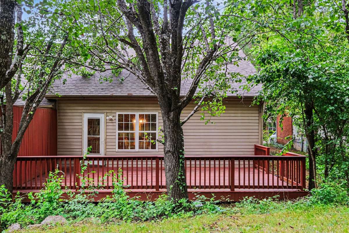 The perfect blend of townhome convenience and outdoor tranquility. This spacious deck provides plenty of room for grilling and entertaining, all while backing up to mature trees for added shade and privacy.