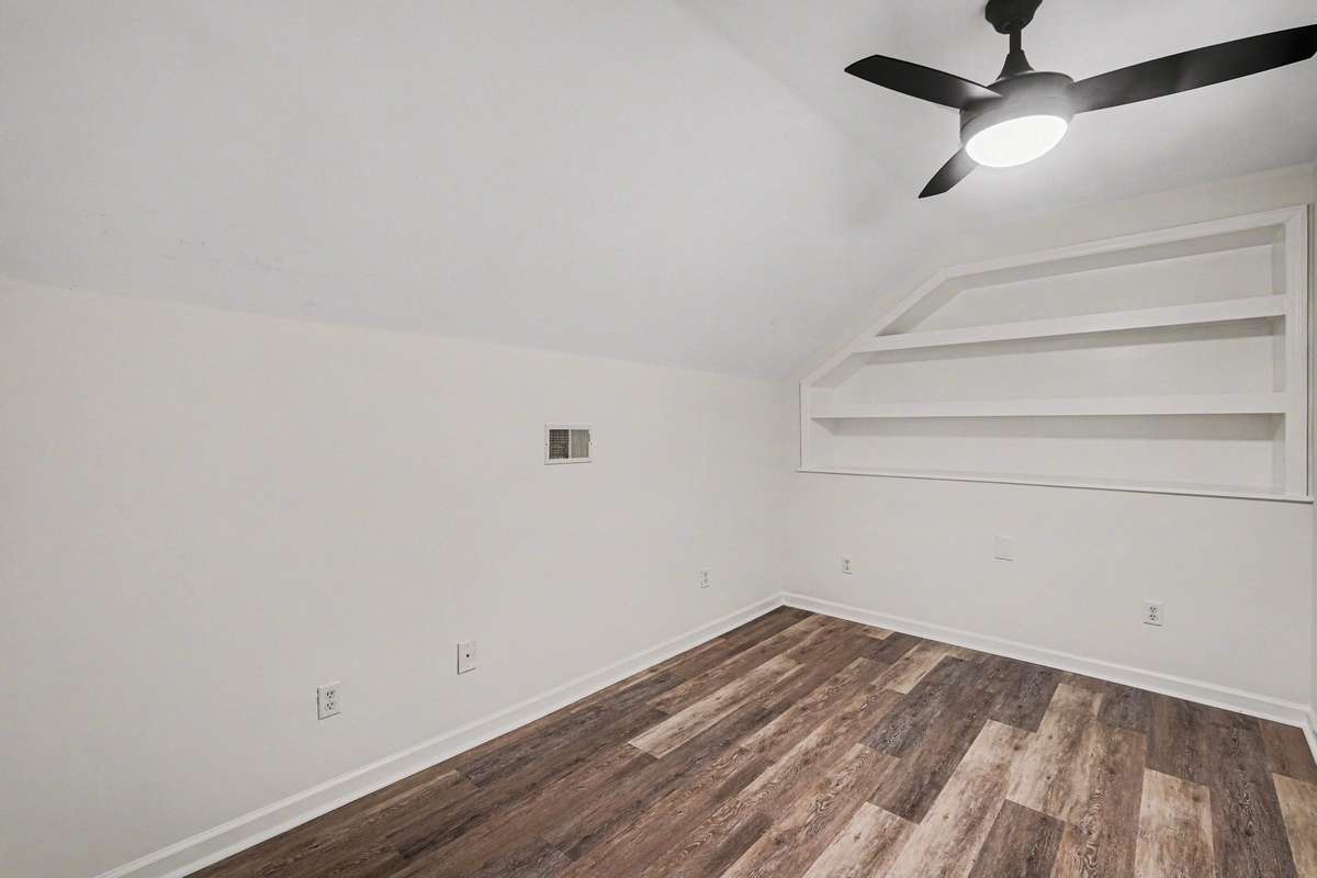 Need a home office or a nursery? This bright upper-level space offers great flexibility! Highlighted by stylish new flooring and a modern light fixture, the built-in nook provides the perfect spot for books or decor, making organization a breeze.