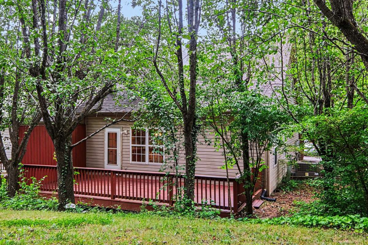 The perfect blend of townhome convenience and outdoor tranquility. This spacious deck provides plenty of room for grilling and entertaining, all while backing up to mature trees for added shade and privacy.