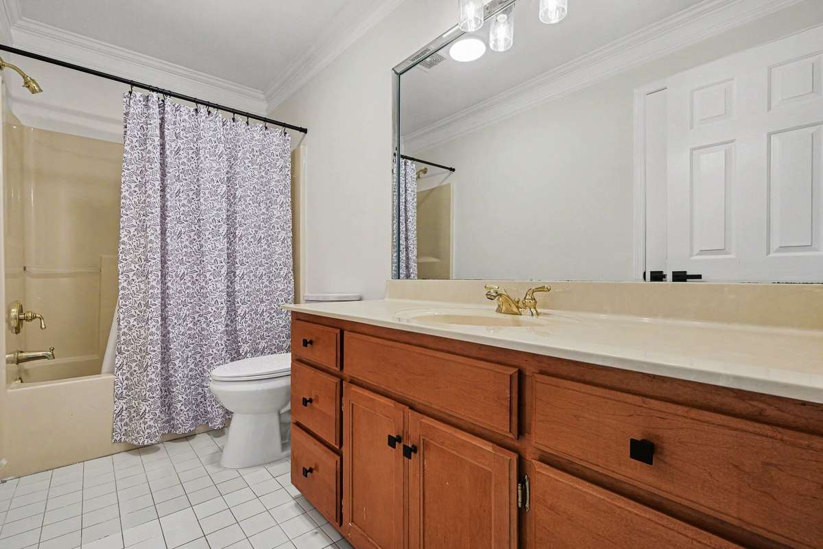 Bright and functional, this main-level full bath boasts ample counter space and updated hardware throughout. The fresh, neutral palette and new lighting make this a clean, move-in-ready space for the next owner.