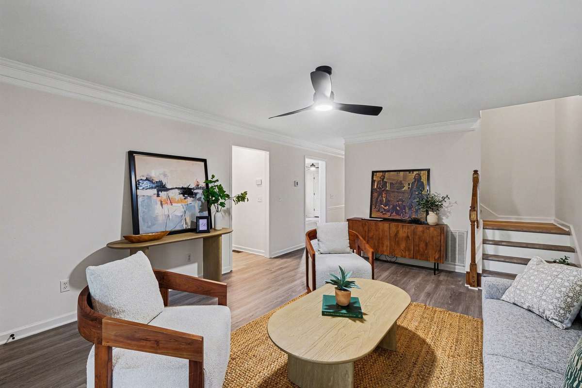 The open and airy floor plan allows for a seamless flow from the living area into the dining and kitchen spaces. This home feels much larger than your average townhome thanks to the bright, neutral paint and consistent new flooring throughout.