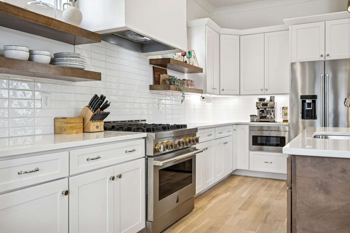 The kitchen boasts premium appliances including a JennAir gas range and KitchenAid refrigerator.