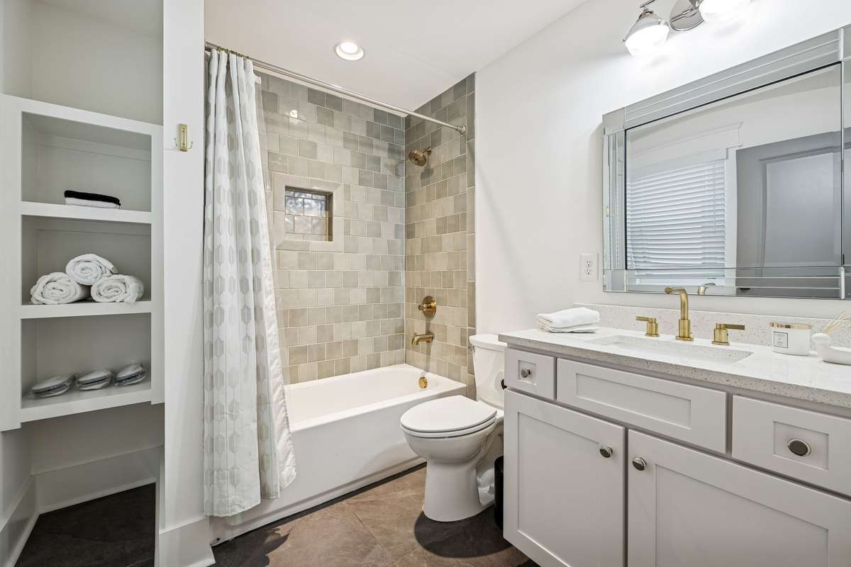 Elegant shower tile and built-in storage in the guest ensuite