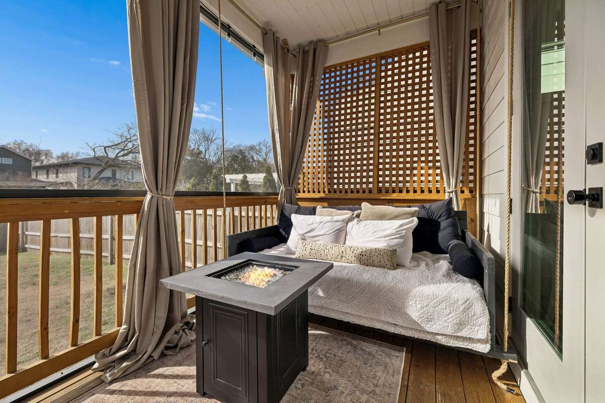 The screened-in back porch with day bed swing is perfect for morning coffee or winding down after a long day.