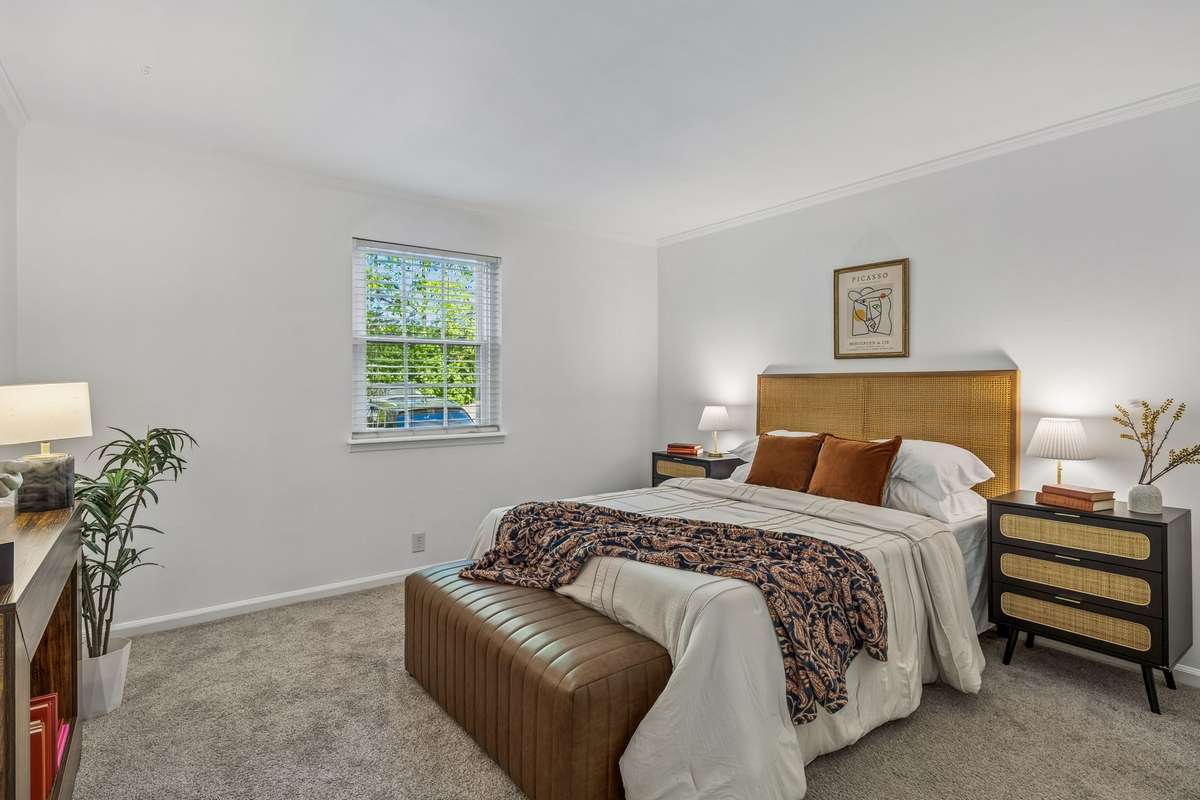 Generous primary room, complete with an ensuite bath and walk-in closet with stackable washer/dryer.