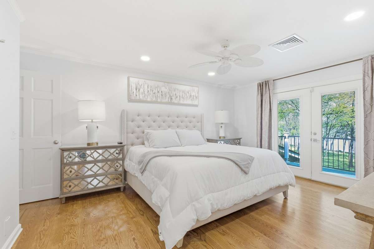 This is the primary bedroom. It has a private balcony area, double closets and beautiful views.