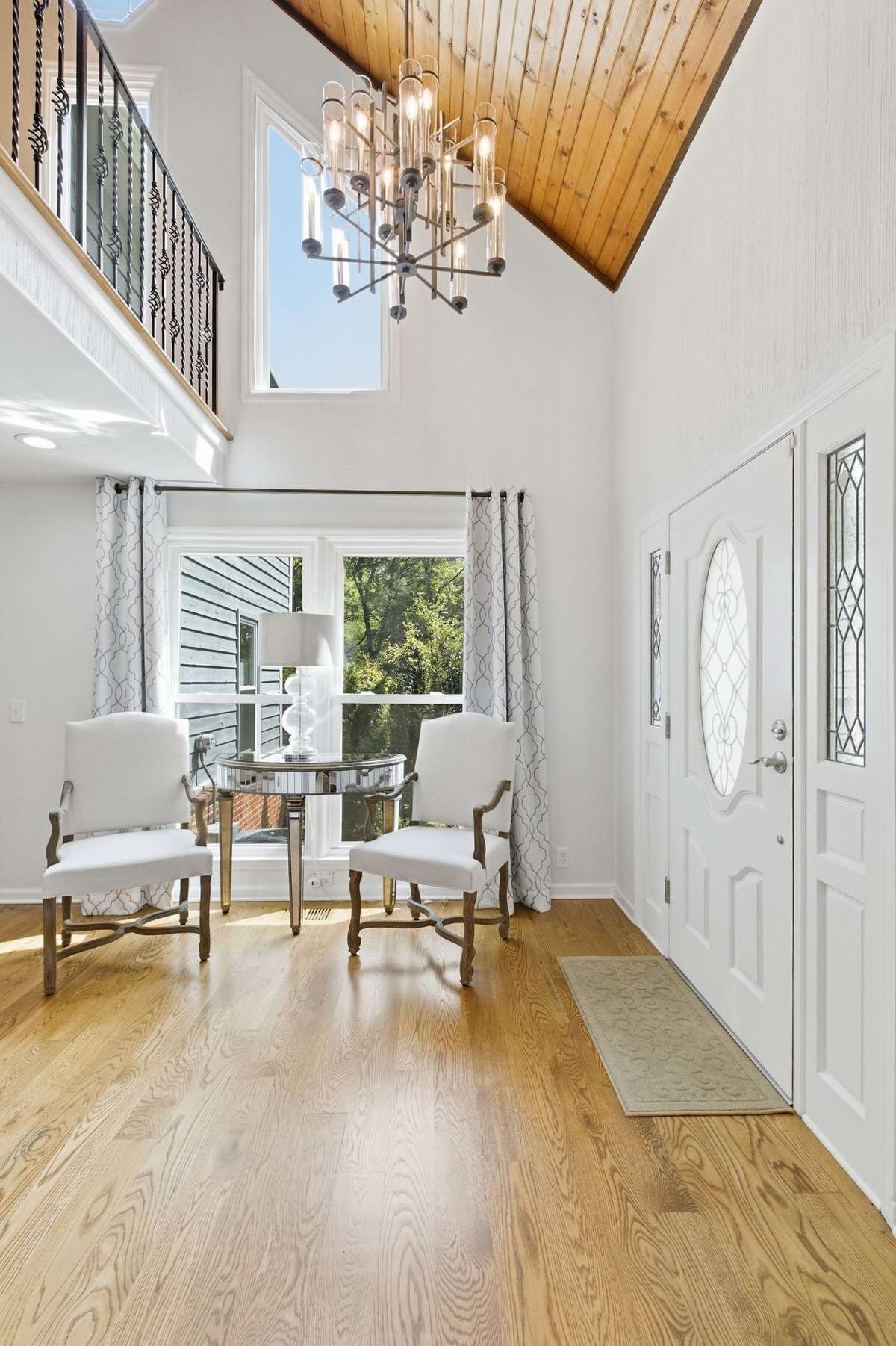 The entryway features hardwood flooring and beautiful lighting.