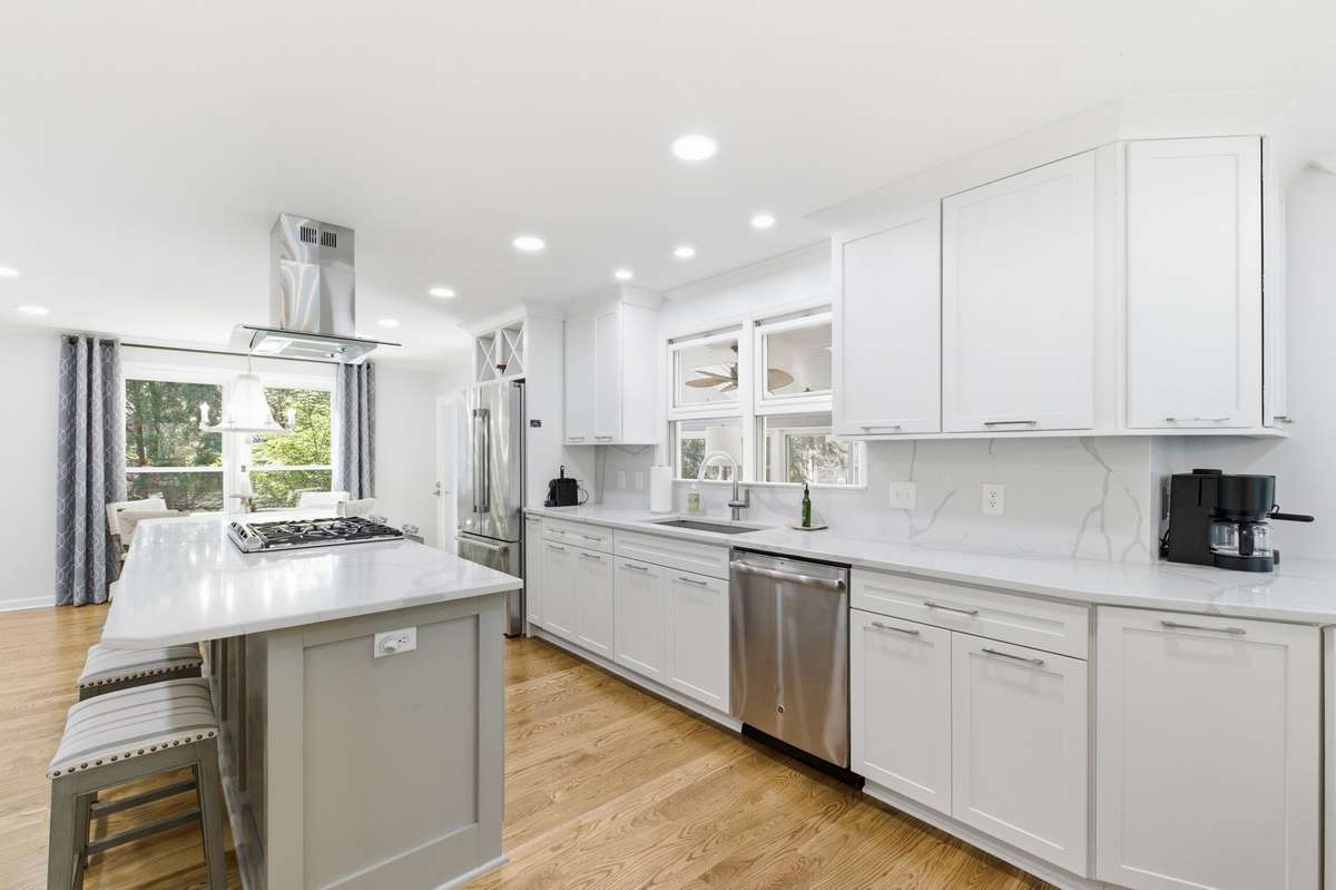 The kitchen has plenty of room for cooking and gathering. It is bright and airy.